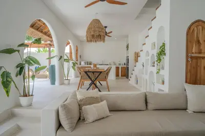 a living room with a couch and a table at Villa Bohemian Seminyak in Seminyak