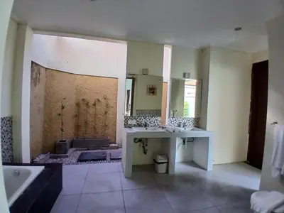 a bathroom with a tub and a sink and a bath tub at Villa Putri in Seminyak Bali in Seminyak