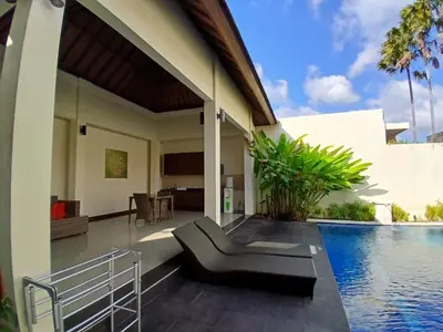 a villa with a swimming pool and a house at Villa Putri in Seminyak Bali in Seminyak