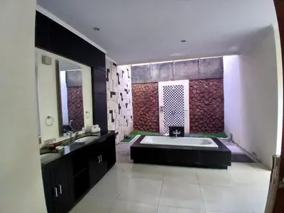 a bathroom with a large tub and two sinks at Villa Putri in Seminyak Bali in Seminyak