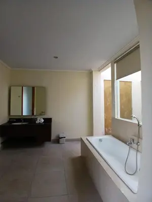 a large bathroom with a tub and a window at Villa Putri in Seminyak Bali in Seminyak