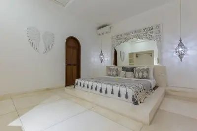 a bedroom with a large bed and a mirror at 3 bedr Mediterranean vibes private pool 5min beach in Seminyak