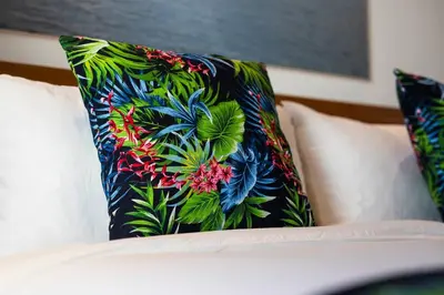 a pillow with a flower design on a couch at Gorgeous 2 Bed Pool Villa, Walk to Seminyak Beach in Seminyak