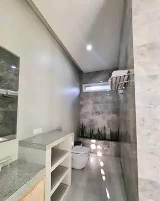 a bathroom with a sink and a toilet at Nikaya Villa - 3 Bedrooms Near Seminyak in Legian