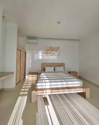 a bedroom with a bed and a bench in it at Nikaya Villa - 3 Bedrooms Near Seminyak in Legian