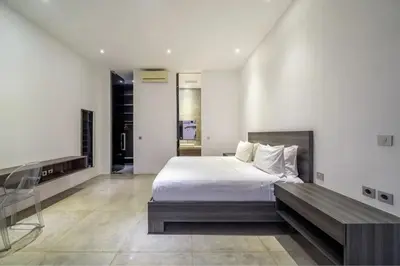 a large bedroom with a bed and a desk at Villa Simpatico Spacious 6 BR Villa Retreat in Central Seminyak in Seminyak