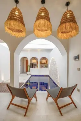 two chairs and two chandeliers in a room with a pool at T&J4 - Romantic 1BR pool villa, walk to beach in Umalas