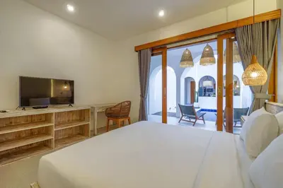 a bedroom with a large bed and a television at T&J4 - Romantic 1BR pool villa, walk to beach in Umalas