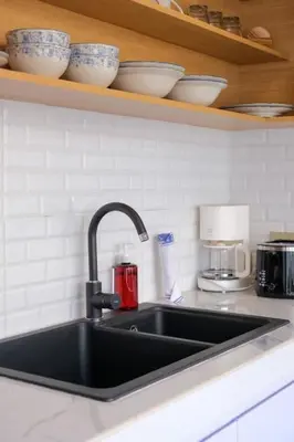 a kitchen sink with cups and bowls on a shelf at T&J5 - New! Romantic 1BR pool villa, walk to beach! in Umalas