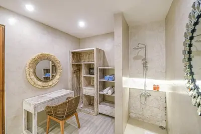 a bathroom with a tub and a table and a mirror at T&J5 - New! Romantic 1BR pool villa, walk to beach! in Umalas