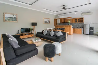 a living room with two couches and a kitchen at 2 villa complex near Atlas beach in Canggu