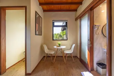 a small dining room with a table and chairs at Cove Kavana in Canggu