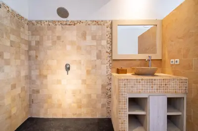 a bathroom with a sink and a mirror at Free pick-up Balinese style tropical private pool villa with 2 bedrooms in Seminyak