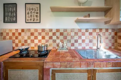 a kitchen with a sink and a stove at Free pick-up Balinese style tropical private pool villa with 2 bedrooms in Seminyak