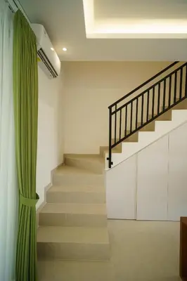 a staircase with a green curtain in a room at Canggu Zen Villa - 2 BR Villa in Berawa in Canggu