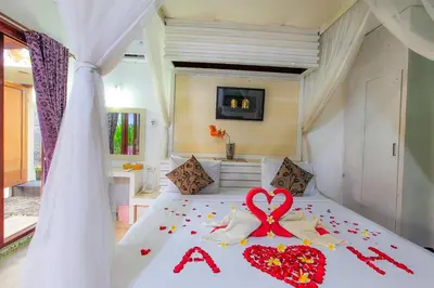 a bedroom with a bed with a heart on it at LV Villa Kuta Bali in Jimbaran