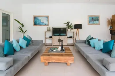 a living room with a couch and a coffee table at 3 neighbour villas 3 pools near Atlas Beach Club in Canggu