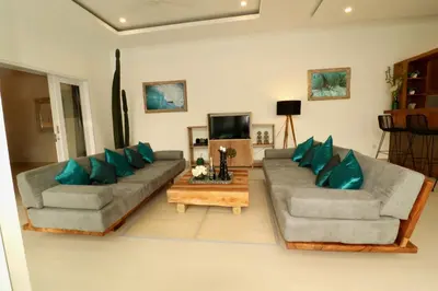 a living room with two couches and a table at 3 neighbour villas 3 pools near Atlas Beach Club in Canggu