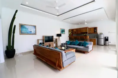 a living room with a couch and a table at 3 neighbour villas 3 pools near Atlas Beach Club in Canggu