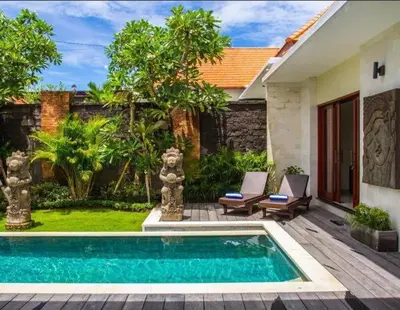 a swimming pool in front of a house at Le Retreat Canggu, 3BR Luxury Villa, Bali's Best Location in Canggu