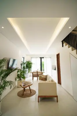 a living room with a couch and a table at Berawa 2BR Private Pool Leon Villa by Bali Bliss Properties in Canggu