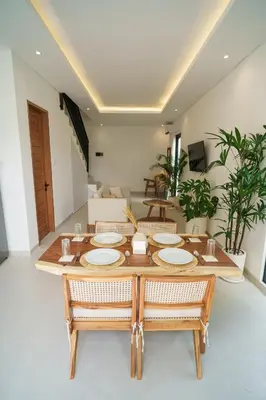 a dining room with a table and chairs at Berawa 2BR Private Pool Leon Villa by Bali Bliss Properties in Canggu