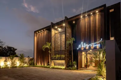 a building with a neon sign in front of it at Miles Coliving in Kerobokan