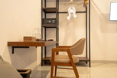 a desk and a chair in a room at Miles Coliving in Kerobokan