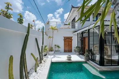 a villa with a swimming pool and a house at Villa bossa nova in Seminyak