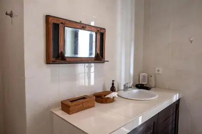 a bathroom with a sink and a mirror at Villa Yuhi in Seminyak