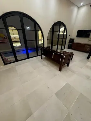 a room with a bench and two large windows at Antanaya Villa Seminyak in Seminyak