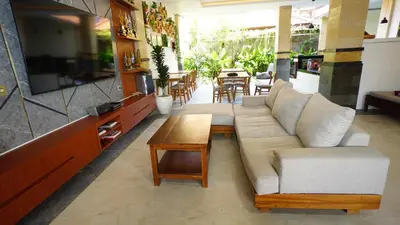 a living room with a couch and a table at BAGUS Guest House in Legian