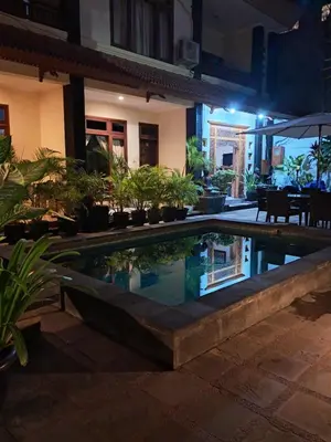 a swimming pool in the middle of a house with plants at SURFARIS INN on poppies 2 in Legian