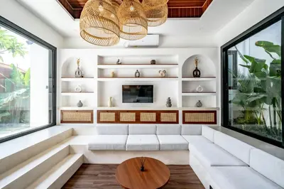 a living room with a white couch and a table at Casa Umari in Canggu