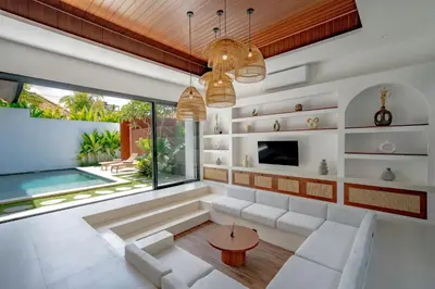 a living room with a couch and a table at Casa Umari in Canggu