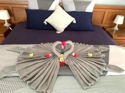 a bed with towels on top of it at Villa D Lima Top Floor in Kuta