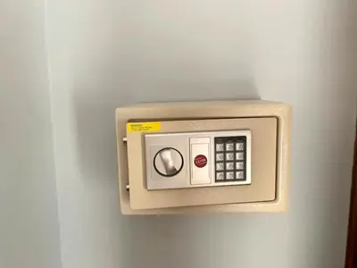 a microwave on a wall in a room at Villa D Lima Top Floor in Kuta