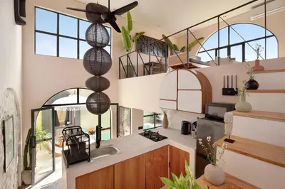 a kitchen with a ceiling fan and some windows at Casa Ghitani Kerobokan 1 Bed Enclose Living room WH2 in Umalas