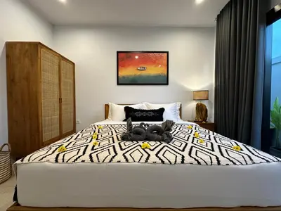 a bedroom with a bed with two teddy bears on it at 2 bedrooms villa cinta umalas in Kerobokan