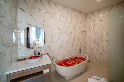 a bathroom with a large tub and a mirror at Villa Bagus Seminyak in Kerobokan