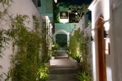 a stairway leading to a building with plants at Dikubu Bali Villa and Suites in Kerobokan