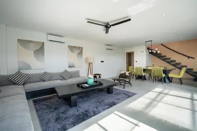 a living room with a couch and a table at Villa Biku in Umalas