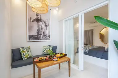 a living room with a table and a bed at The Hepburn Seminyak ADULTS ONLY Chic Boutique Room with Pool 900m Walk to Beach in Seminyak
