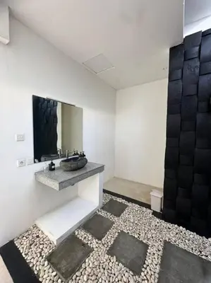a bathroom with a sink and a mirror at Villa umara 2 kerobokan close to seminyak in Seminyak