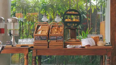 a table with bread and other foods on it at SOLTERRA SEMINYAK Boutique Hotel & Spa Powered by Archipelago in Seminyak