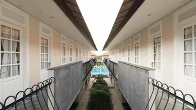 an internal corridor of a building with a pool at SOLTERRA SEMINYAK Boutique Hotel & Spa Powered by Archipelago in Seminyak
