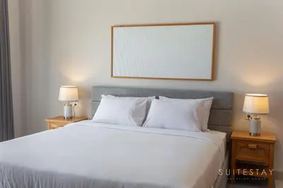 a bedroom with a large white bed with two lamps at Two Bedroom Villa with Outdoor Pool in Umalas