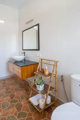 a bathroom with a sink and a shelf and a mirror at Two Bedroom Villa with Outdoor Pool in Umalas