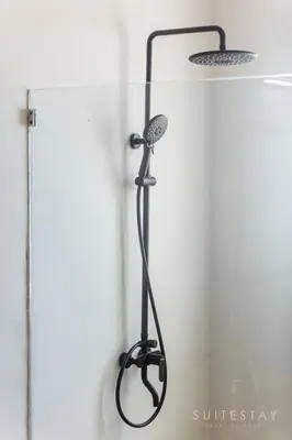 a shower in a bathroom with a shower head at Two Bedroom Villa with Outdoor Pool in Umalas