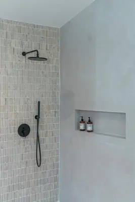 a bathroom with a shower with a shower head at Casa Kameelya - Modern Tropical 4BR Villa in Central Canggu in Canggu